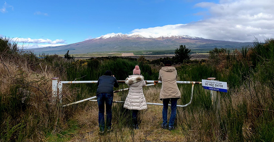 Desert road intermission, family and friends taking pictures of Mount Ruapehu